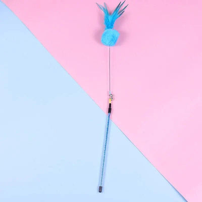 Cat teaser wand with bell and feathers against a pink and blue background.