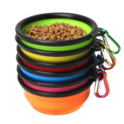 Folding portable silicone dog feeder bowls with carabiners in multiple colors, filled with dog food.