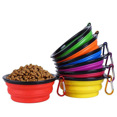 Folding portable silicone dog feeder bowls with carabiners, stacked in multiple colors, ideal for food and water.