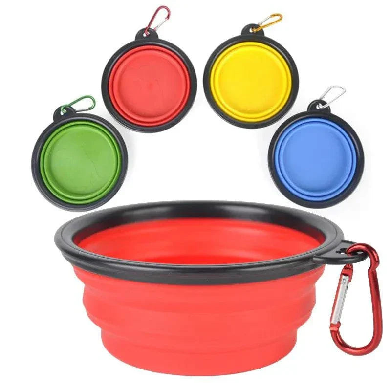 Folding portable silicone dog feeder bowl with carabiner in red, green, yellow, and blue colors.