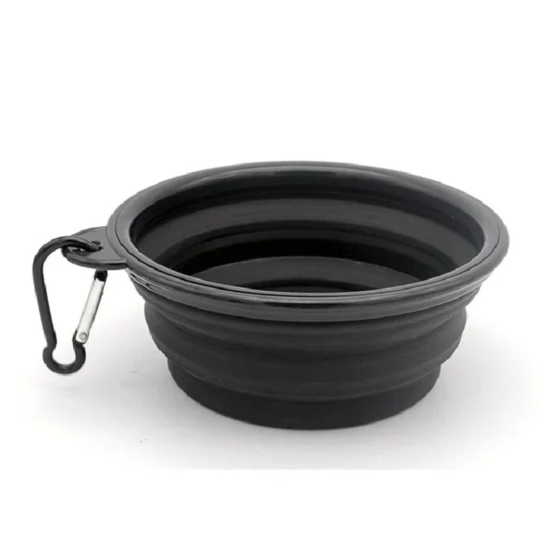 Folding portable silicone dog feeder bowl with carabiner for food and water.