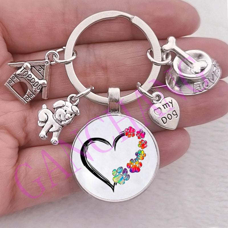 Cute dog paw keychain with glass pendant and antique silver plated charms.