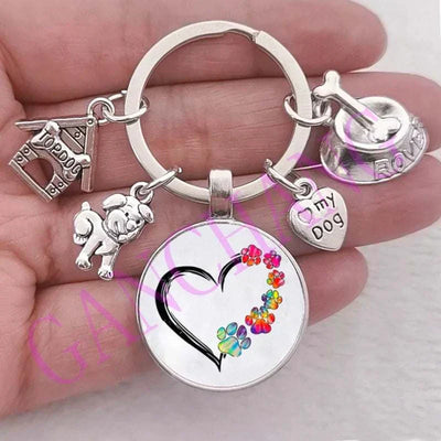 Cute dog keychain with antique silver plated glass pendant featuring colorful heart design.