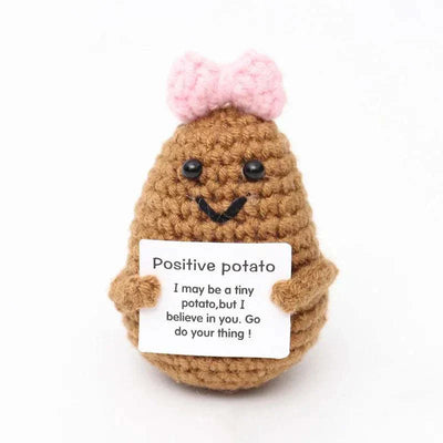 Handwoven crochet duck ornament holding a positive message sign.