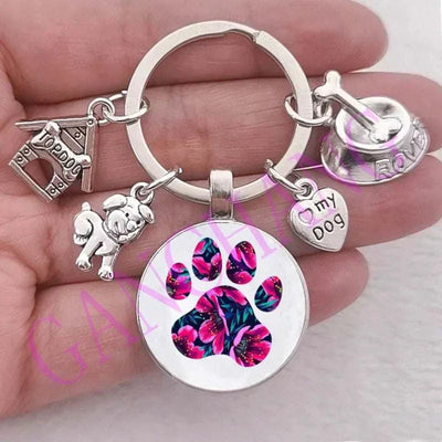 Cute dog paw keychain with glass pendant in antique silver.