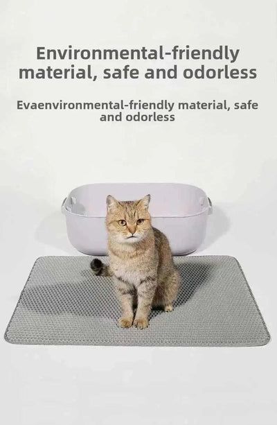 Cat sitting on a double-layer cat litter mat, waterproof and non-slip, next to a litter box.