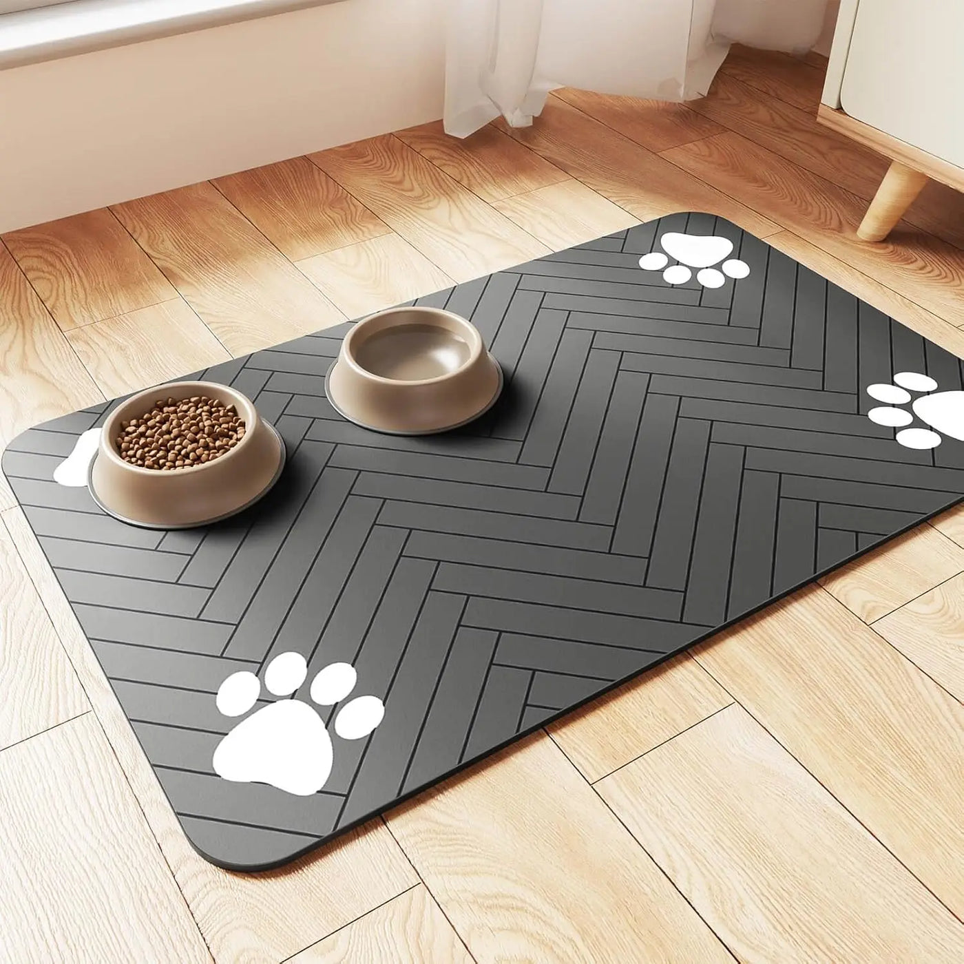 Absorbent dog feeding mat with paw prints, waterproof and quick-dry, placed on wooden floor with food and water bowls.