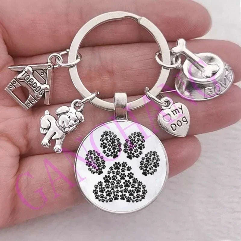 Cute dog paw keychain with glass pendant and charms, antique silver plated, unisex fashion accessory.