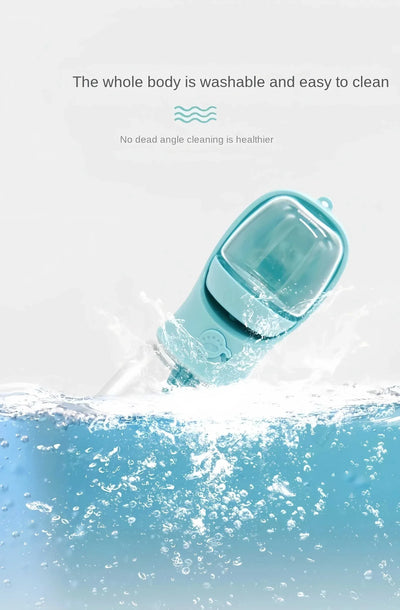 Portable pet water bottle submerged in water to demonstrate washability and easy cleaning.