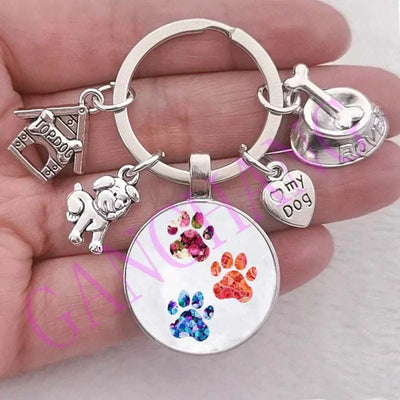 Cute dog keychain with glass pendant featuring colorful paw prints and silver charms.