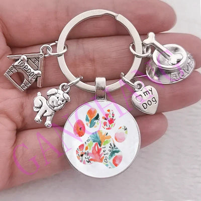 Cute dog paw keychain with glass pendant and dog-themed charms.