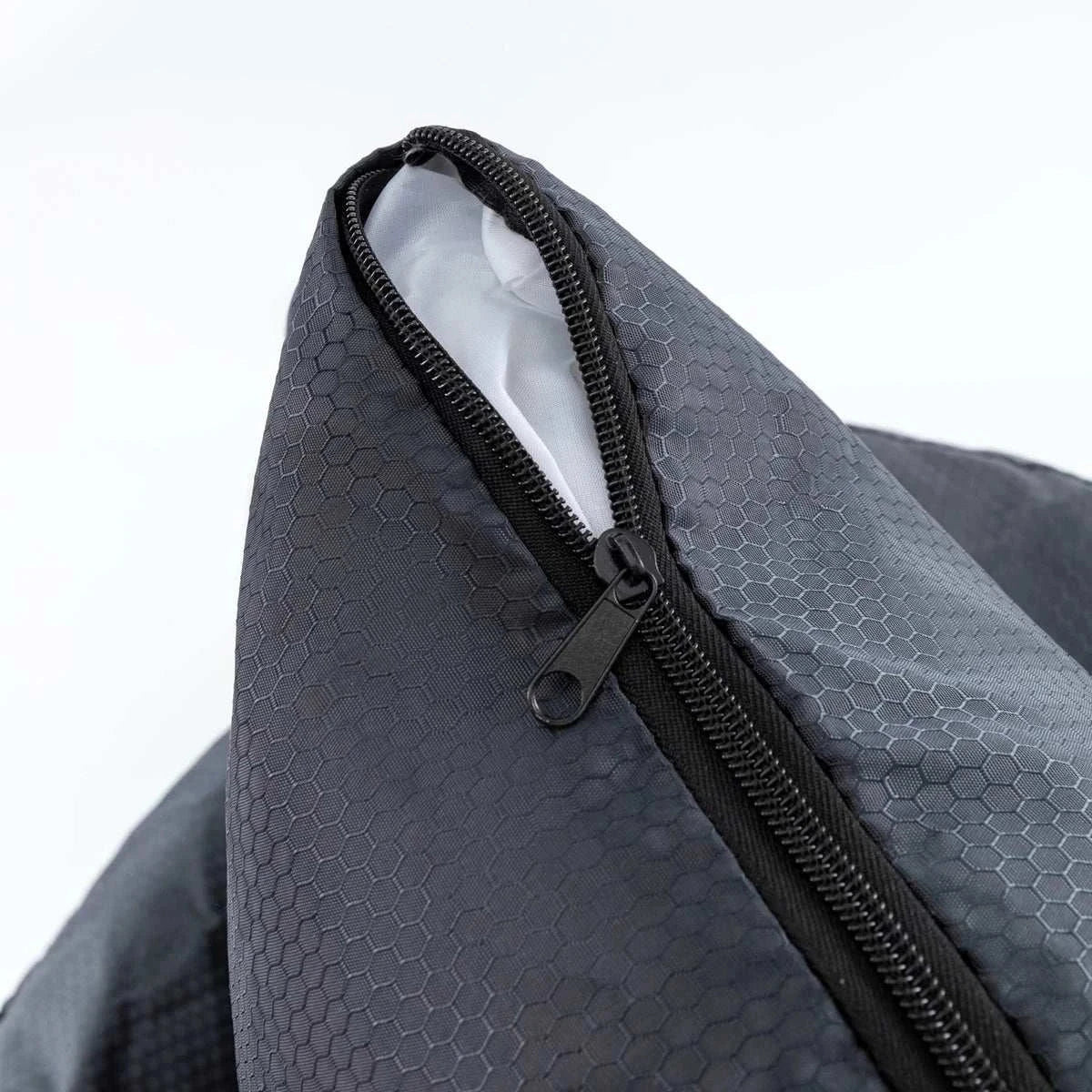 Close-up of a gray polyester car seat cover for small dogs, featuring a zipper and breathable design.